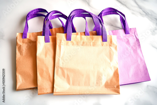 Brown and purple paper bags with handles, arranged on a marble surface photo