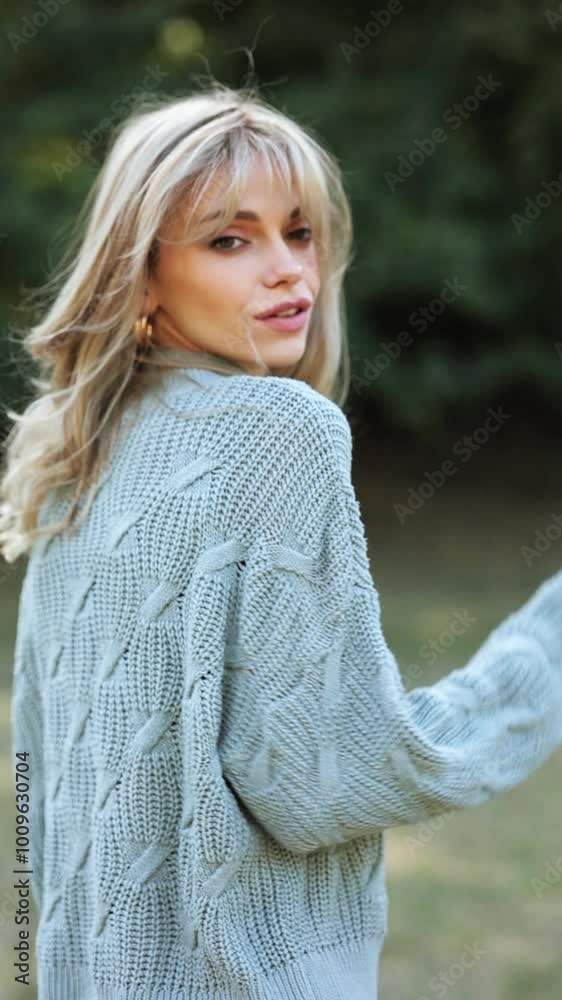 A charming stylish young girl walks through an autumn park and enjoys a warm day. Slow motion. Vertical frame
A charming stylish young girl walks through an autumn park and enjoys a warm day. Slow motion. Vertical frame