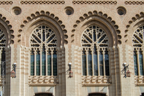 Neo-Mudejar style brick lobed arch windows on the facade of the train station in Toledo. Spain