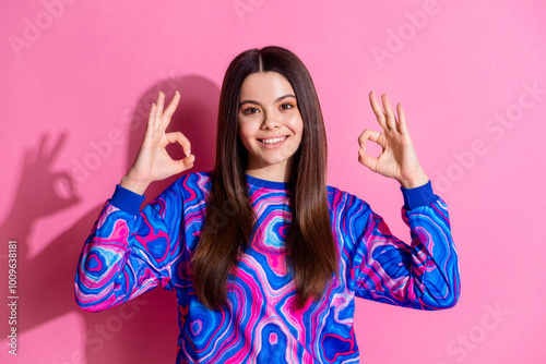 Photo portrait of pretty teen girl show okey wear trendy colorful outfit isolated on pink color background