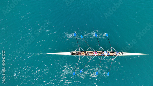 Obraz na płótnie Aerial drone photo of sport canoe operated by team of young trained athletes in deep emerald sea w salonie