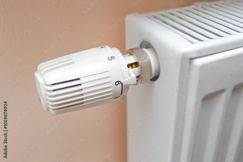 Temperature control knob on room battery. Metal radiator with individual control. heating system, energy crisis, energy saving, heat saving, heating season Temperature control knob on room battery. Metal radiator with individual control. heating system, energy crisis, energy saving, heat saving, heating season