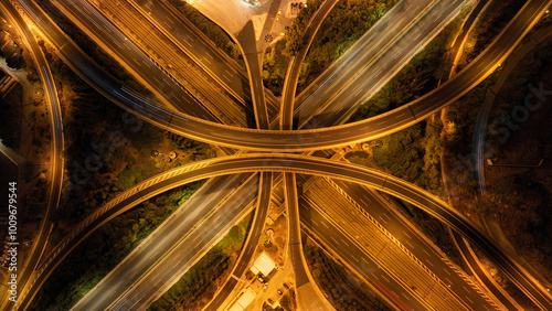 Obraz na płótnie Aerial drone long exposure night shot of highway multilevel junction highway with light traffic leaving car headlights white and red trails w salonie