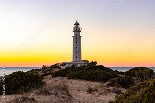 Cuadro en lienzo Sunset Serenity at Cape Trafalgar: Lighthouse, Sand, and Sea