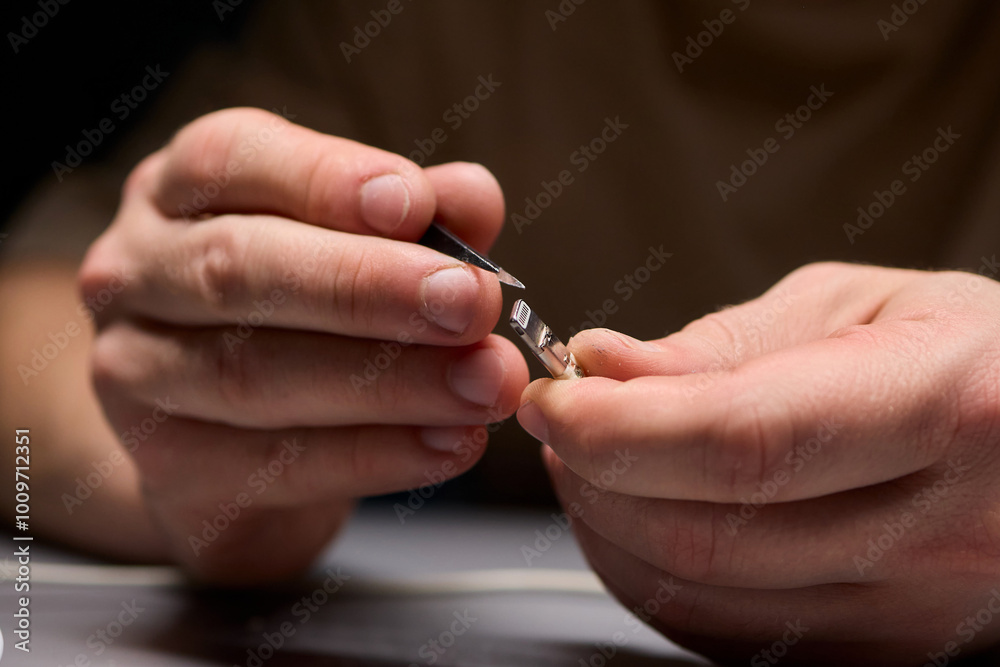 Hands Firmly Holding USB and Connector Cables for the Purpose of Electronics Repair Work Hands Firmly Holding USB and Connector Cables for the Purpose of Electronics Repair Work