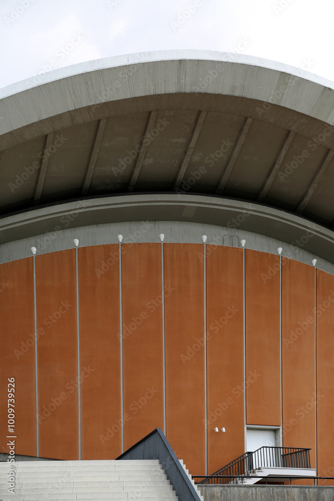 Fototapeta premium Unique curves and modern design of the House of World Cultures in Berlin, Germany rise against a backdrop of soft clouds, showcasing the blend of architecture and nature in the city