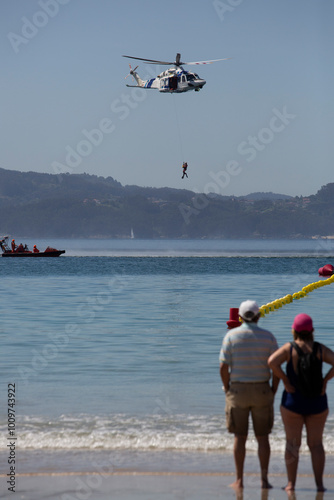 Canvas Print Maritime rescue helicopter rescues a bather on Silgar beach, Sanxenxo