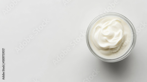 "Top view of sour cream or yogurt in a glass bowl, isolated on a white background, showcasing full depth of field."