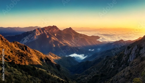 Majestic mountain range at sunrise, with soft clouds rolling through the valleys and warm light touching the peaks