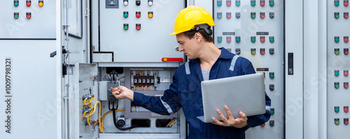 Electrical engineer working in control room. Electrical engineer man checking Power Distribution Cabinet in the control room