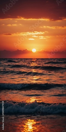 The warm glow of the setting sun casts golden hues over the tranquil waves of the ocean, creating a serene atmosphere by the shoreline during dusk. Sunset or sunrise at sea. Romantic landscape. AI