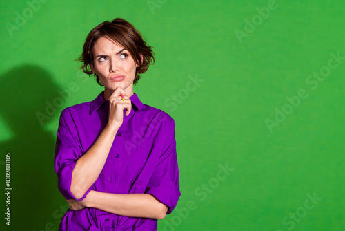 Photo portrait of brown bob haired hipster girl in purple shirt touch chin looking novelty logical solution isolated on green color background