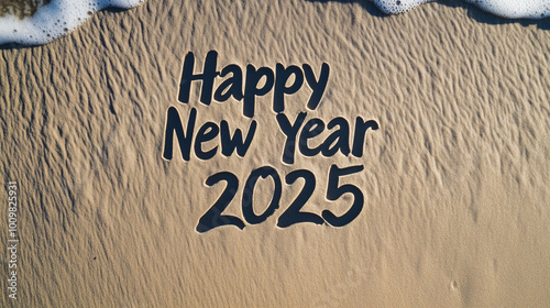 Obraz na płótnie Handwritten text Happy New Year 2025 on smooth golden beach sand, morning light casting soft shadows w salonie