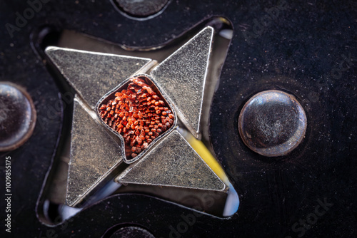 Macro shot of a wire crimping tool with blue cable in a star-shaped die. Close-up of electrical equipment. photo