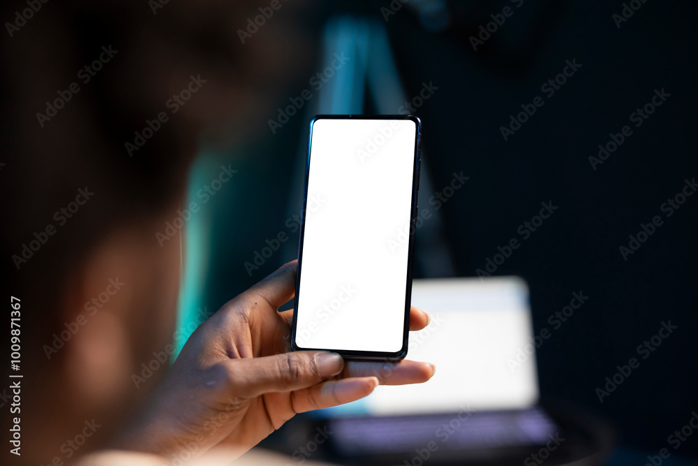 BIPOC man chatting with online friends using mockup phone in warm stylish home, enjoying himself. Person scrolling on isolated screen cellphone, relaxing by scrolling on social media BIPOC man chatting with online friends using mockup phone in warm stylish home, enjoying himself. Person scrolling on isolated screen cellphone, relaxing by scrolling on social media