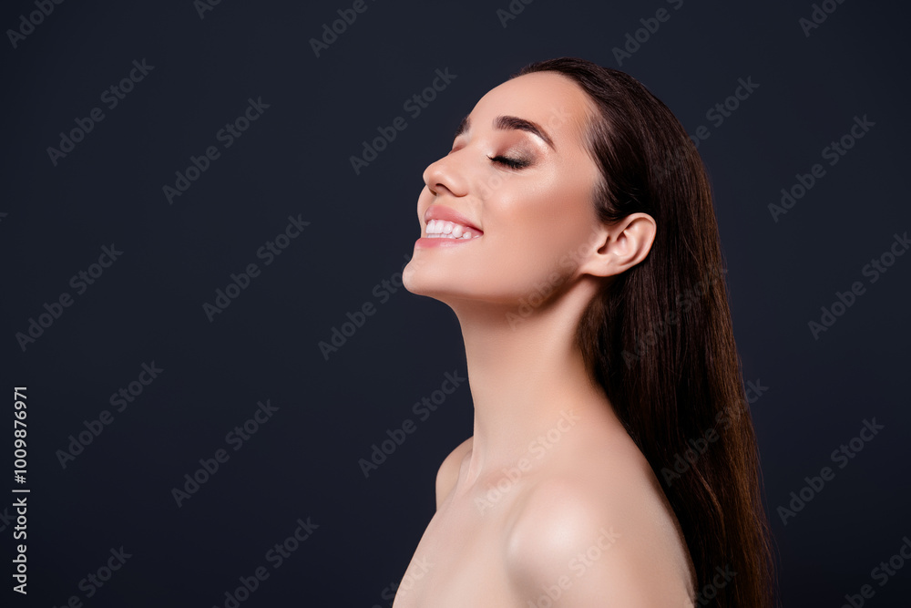 Photo of stunning gorgeous cheerful lady nude shoulders closed eyes isolated on dark grey color background Photo of stunning gorgeous cheerful lady nude shoulders closed eyes isolated on dark grey color background