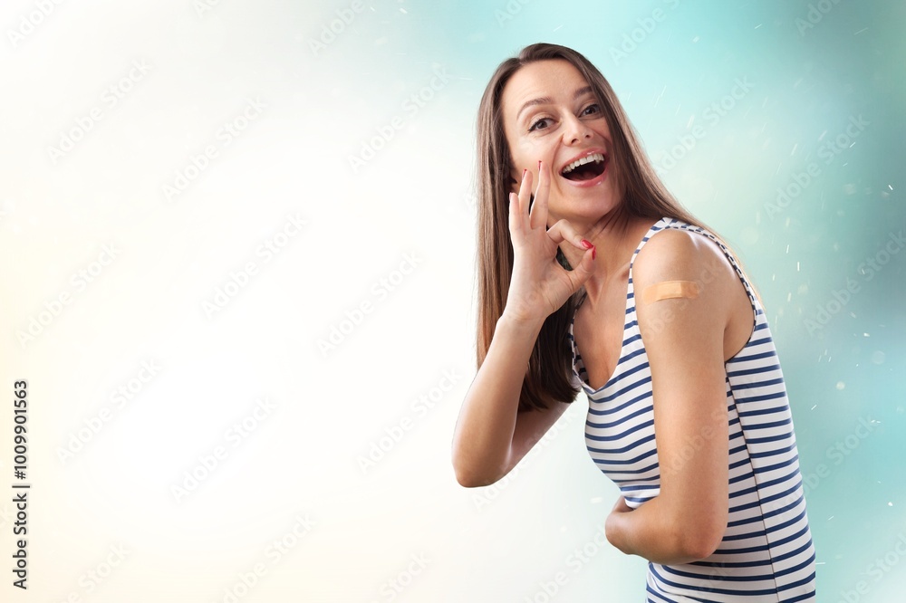 Fototapeta premium Teenager happy woman showing bandage after vaccine. health concept.