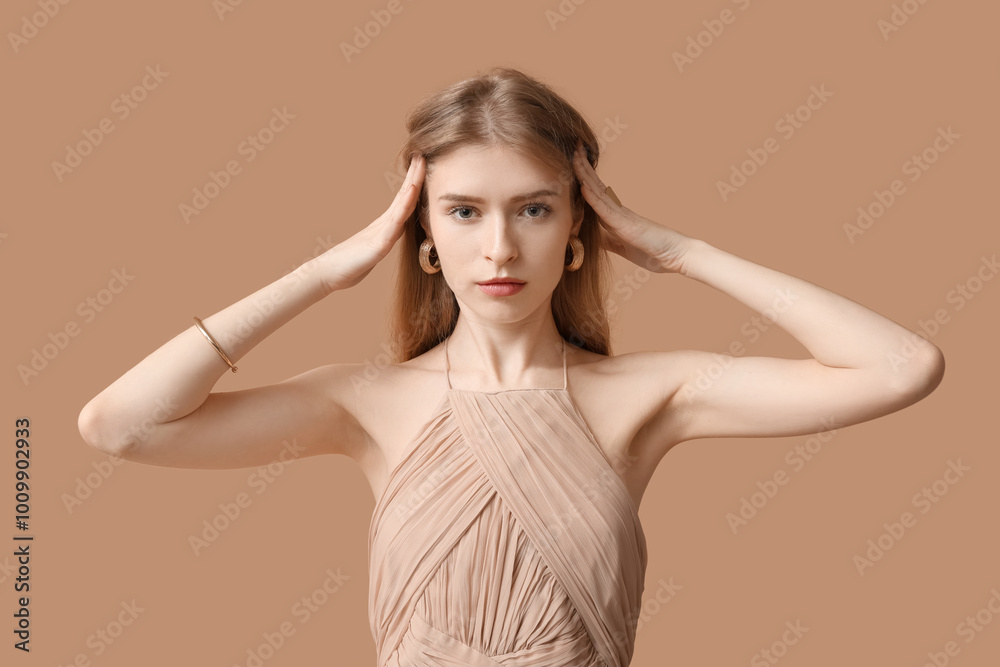 Fototapeta premium Beautiful young woman with stylish jewelry on brown background