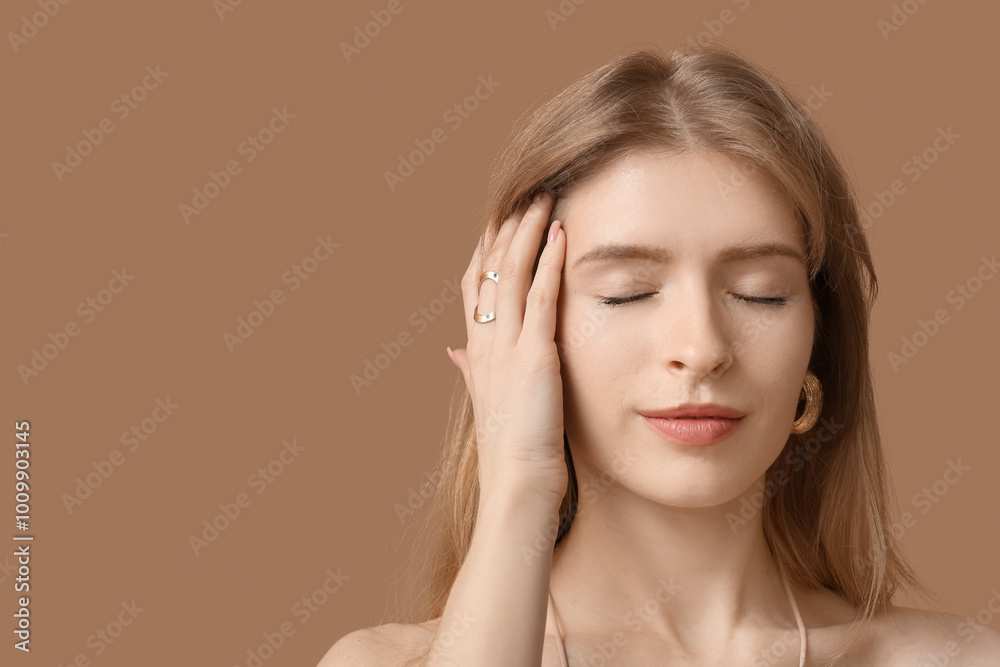 Beautiful young woman with stylish jewelry on brown background Beautiful young woman with stylish jewelry on brown background