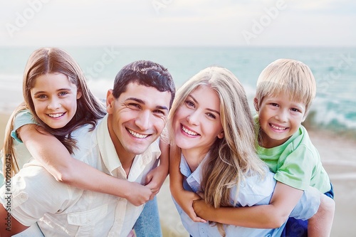 Running, playing happy young family at a beach