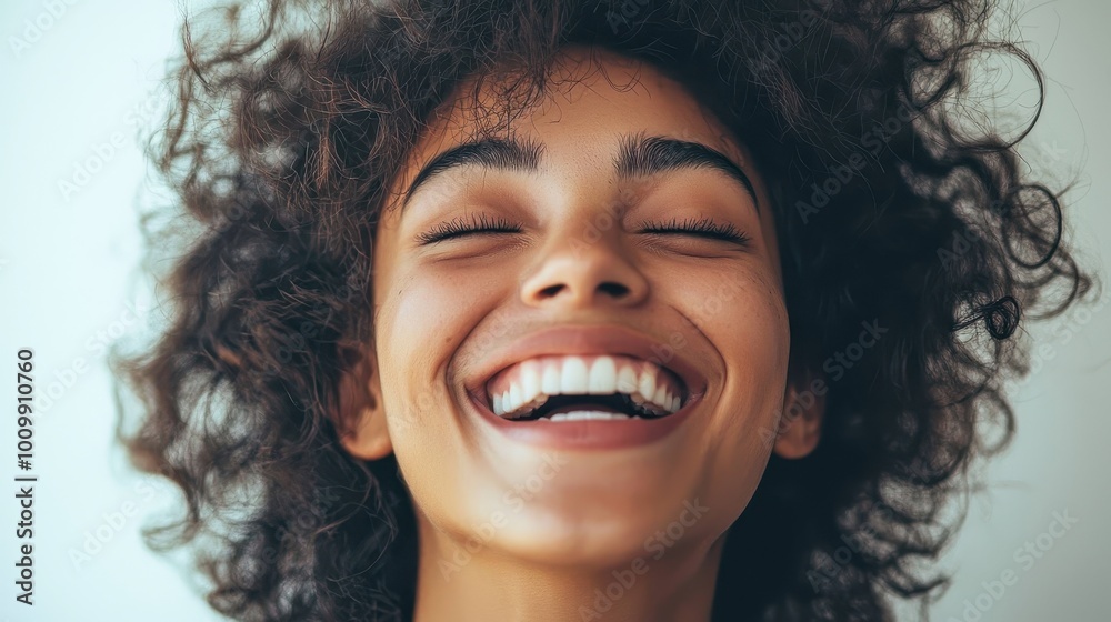 Joyful Expression of a Young Woman with Curly Hair Joyful Expression of a Young Woman with Curly Hair