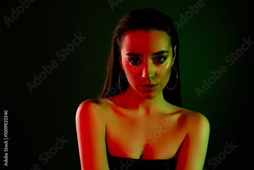 Portrait of confident gorgeous young lady empty space ad colorful neon lights dark background