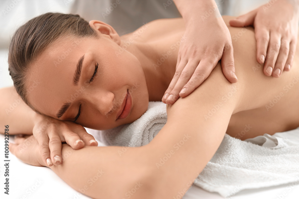 Beautiful young woman getting shoulder massage in spa salon, closeup Beautiful young woman getting shoulder massage in spa salon, closeup
