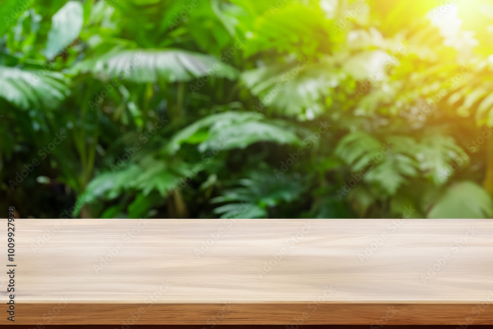 Empty wooden table top with blurred green leaf background. Empty wooden table top with blurred green leaf background.