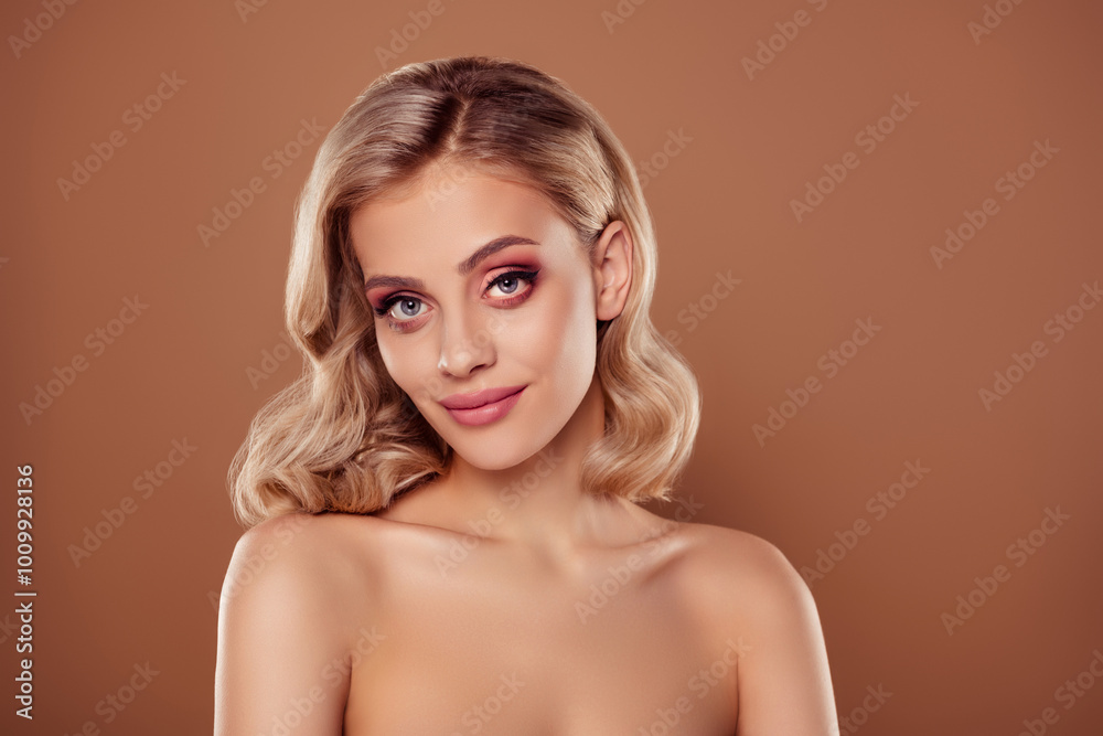 Portrait of attractive girl with blonde curly hairstyle look isolated over beige brown color background Portrait of attractive girl with blonde curly hairstyle look isolated over beige brown color background