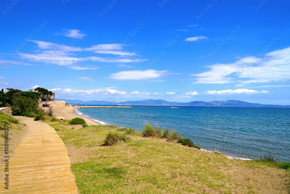 view from the Camí de Ronda hiking trail over the Golf de Roses and the Mediterranean Sea towards Roses and the Pyrenees at the horizon, l'Escala, Costa Brava, Girona, Figueres, Spain view from the Camí de Ronda hiking trail over the Golf de Roses and the Mediterranean Sea towards Roses and the Pyrenees at the horizon, l'Escala, Costa Brava, Girona, Figueres, Spain