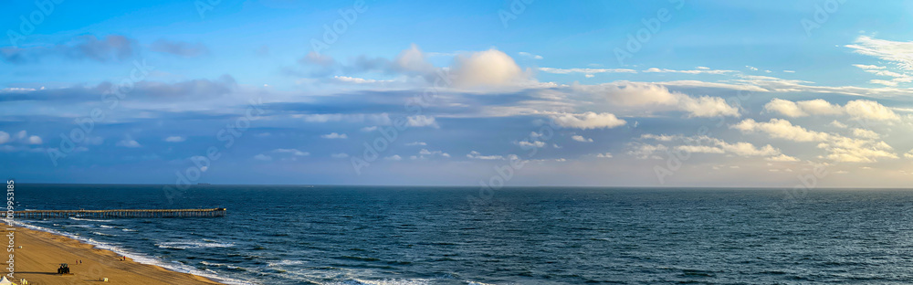 Seascape with stipe of sand stripe and fishing peer on Virginia Beach shoreline Seascape with stipe of sand stripe and fishing peer on Virginia Beach shoreline