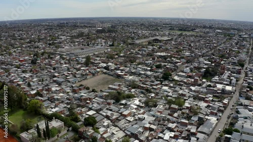 Drone footage showing an aerial view of Boulogne, a marginalized neighborhood in Buenos Aires, Argentina. The expansive shot reveals dense housing, with informal structures. photo