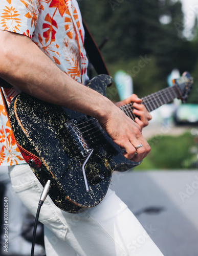 Photography Concert view of electric guitar player with vocalist and rock band performing on