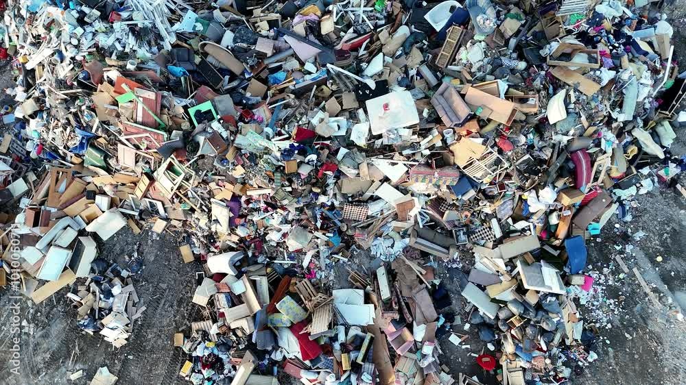 4k aerial view of a large landfill filled with mixed household and construction waste.