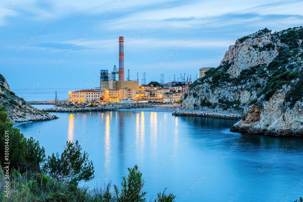 Obraz premium Mediterranean coast with power plant and its coal pier in the town.