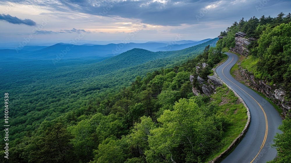 Fototapeta premium Serene Mountain Road Amidst Lush Green Landscape