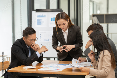 Group of Asian businessmen are giving a presentation in the company.