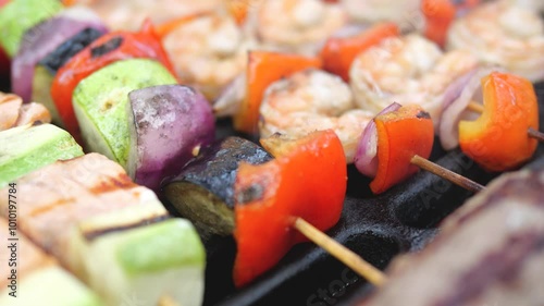Barbecue with grilled meat and vegetables. variety of food is fried on an iron grill over fire. Delicious food. outdoor picnic. Cooking meat on fire. cutlets burgers shrimps vegetables are cooked