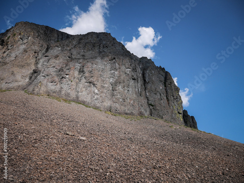 Tall rock wall cliff at top of scree field in Sawtooth Mountains in Challis National Forest