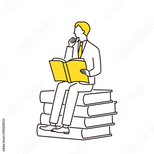本に座って読書をするビジネスマン