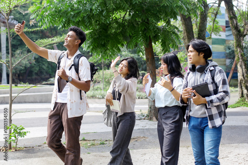 Happy Asian College Students Taking Selfie On Smartphone While Walking Together On Campus 