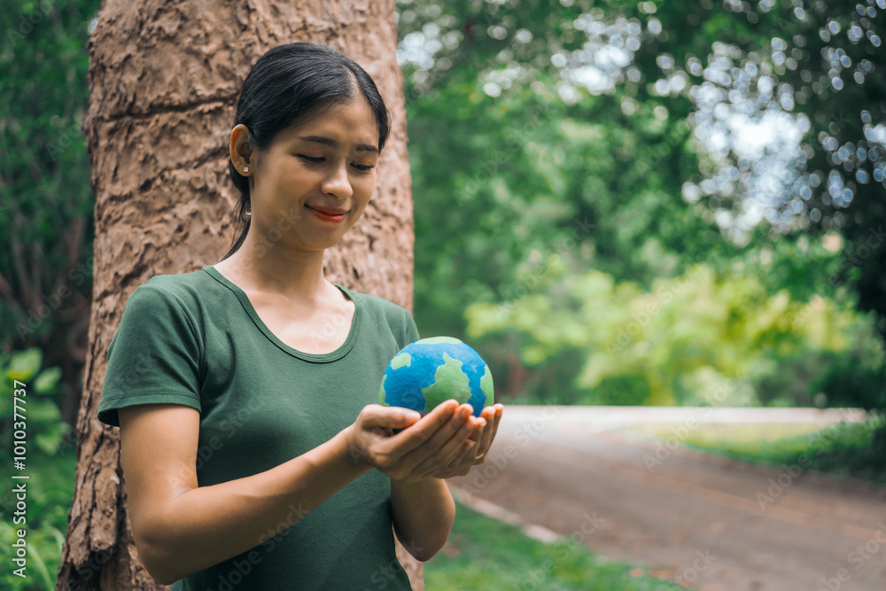 An Asian woman holds a globe in a green forest,symbolizing the importance of preserving nature.emphasizes balance between humans, natural resources,sustainable environmental development protect An Asian woman holds a globe in a green forest,symbolizing the importance of preserving nature.emphasizes balance between humans, natural resources,sustainable environmental development protect
