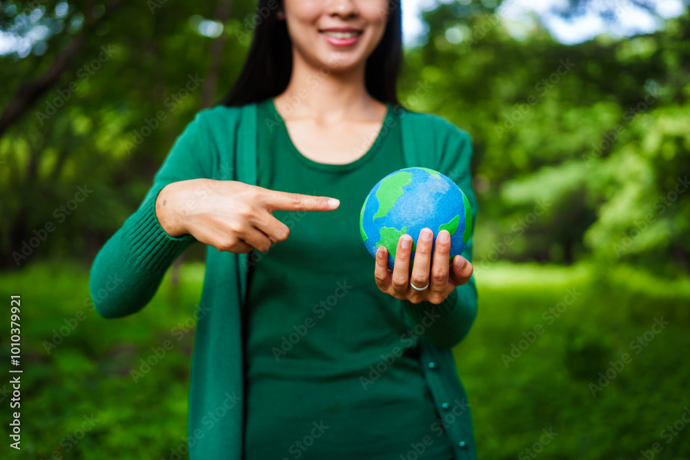 An Asian woman holds a globe in a green forest,symbolizing the importance of preserving nature.emphasizes balance between humans, natural resources,sustainable environmental development protect An Asian woman holds a globe in a green forest,symbolizing the importance of preserving nature.emphasizes balance between humans, natural resources,sustainable environmental development protect