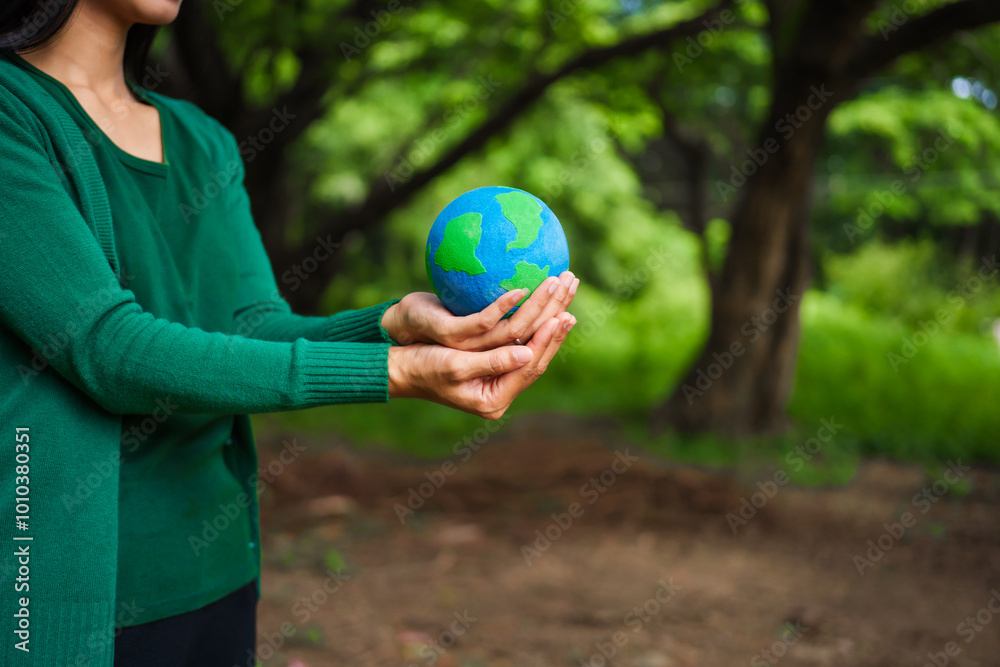 An Asian woman holds a globe in a green forest,symbolizing the importance of preserving nature.emphasizes balance between humans, natural resources,sustainable environmental development protect An Asian woman holds a globe in a green forest,symbolizing the importance of preserving nature.emphasizes balance between humans, natural resources,sustainable environmental development protect