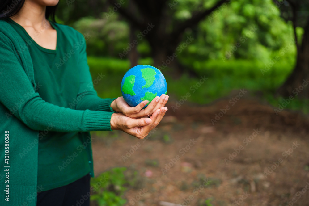 An Asian woman holds a globe in a green forest,symbolizing the importance of preserving nature.emphasizes balance between humans, natural resources,sustainable environmental development protect An Asian woman holds a globe in a green forest,symbolizing the importance of preserving nature.emphasizes balance between humans, natural resources,sustainable environmental development protect
