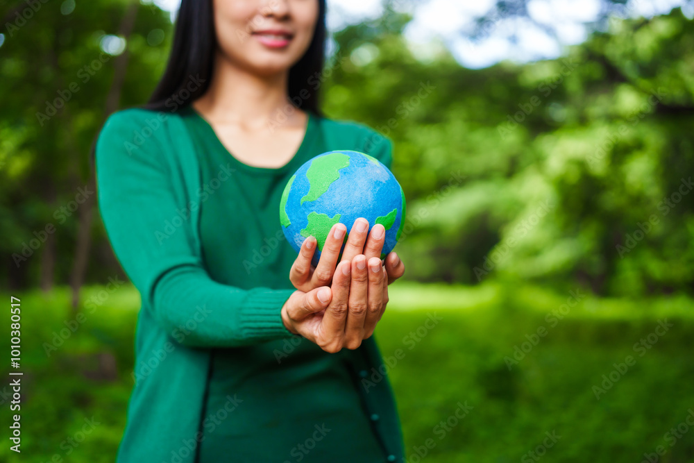 An Asian woman holds a globe in a green forest,symbolizing the importance of preserving nature.emphasizes balance between humans, natural resources,sustainable environmental development protect An Asian woman holds a globe in a green forest,symbolizing the importance of preserving nature.emphasizes balance between humans, natural resources,sustainable environmental development protect