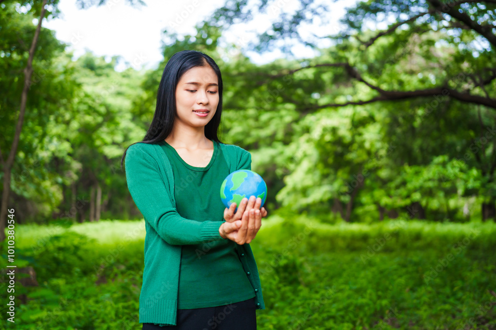 An Asian woman holds a globe in a green forest,symbolizing the importance of preserving nature.emphasizes balance between humans, natural resources,sustainable environmental development protect An Asian woman holds a globe in a green forest,symbolizing the importance of preserving nature.emphasizes balance between humans, natural resources,sustainable environmental development protect