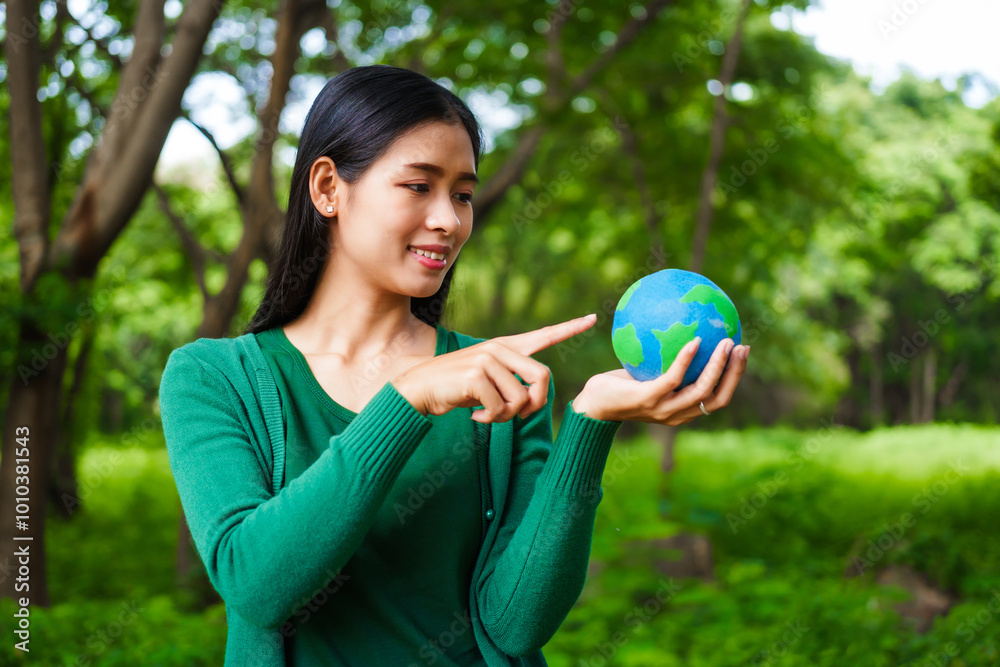 An Asian woman holds a globe in a green forest,symbolizing the importance of preserving nature.emphasizes balance between humans, natural resources,sustainable environmental development protect An Asian woman holds a globe in a green forest,symbolizing the importance of preserving nature.emphasizes balance between humans, natural resources,sustainable environmental development protect