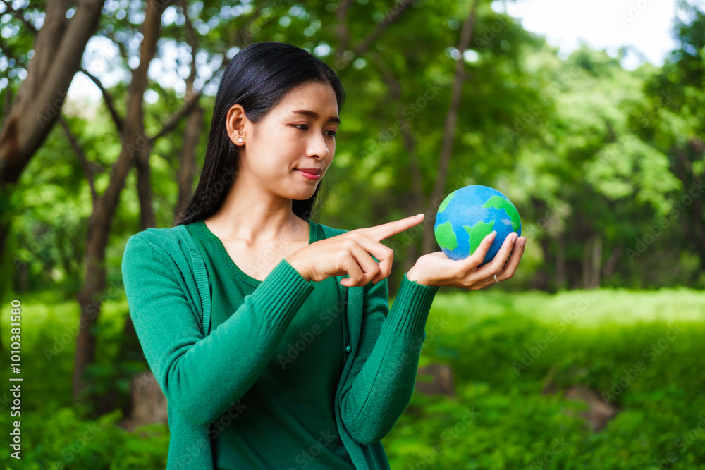 An Asian woman holds a globe in a green forest,symbolizing the importance of preserving nature.emphasizes balance between humans, natural resources,sustainable environmental development protect An Asian woman holds a globe in a green forest,symbolizing the importance of preserving nature.emphasizes balance between humans, natural resources,sustainable environmental development protect