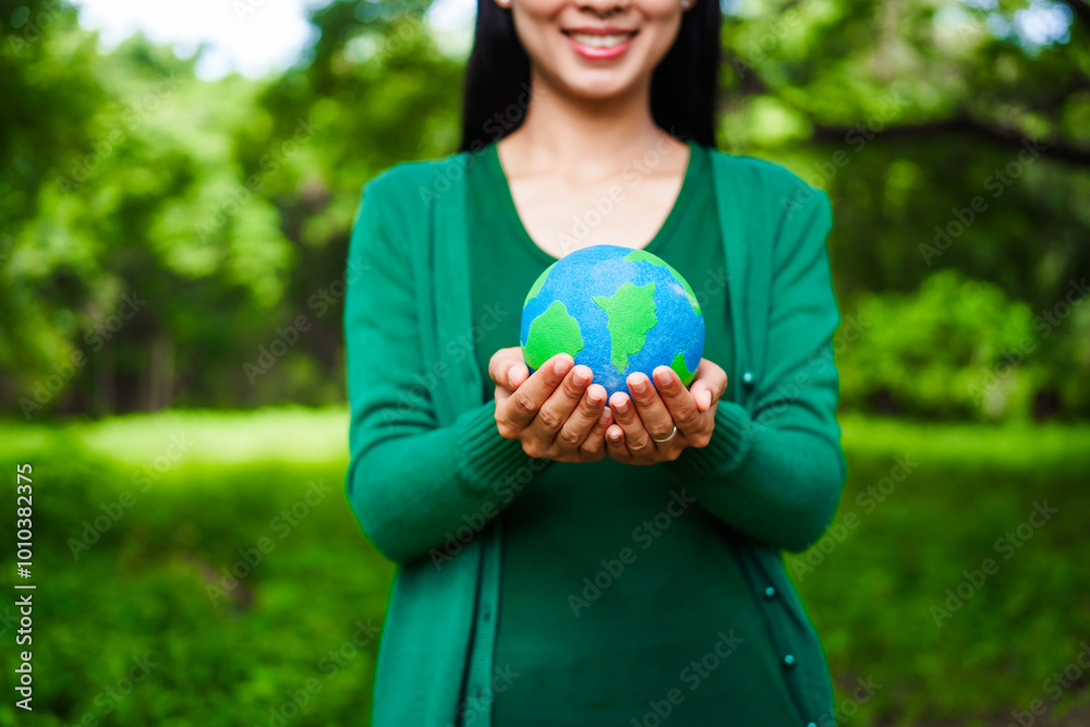 An Asian woman holds a globe in a green forest,symbolizing the importance of preserving nature.emphasizes balance between humans, natural resources,sustainable environmental development protect An Asian woman holds a globe in a green forest,symbolizing the importance of preserving nature.emphasizes balance between humans, natural resources,sustainable environmental development protect
